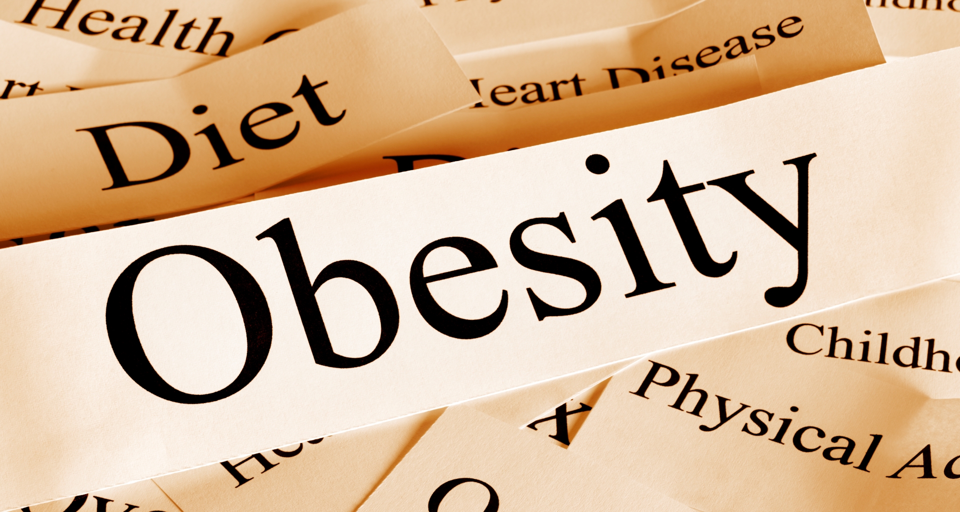 Pieces of paper with the words obesity, heart disease, physical activity, diet and childhood written on them.