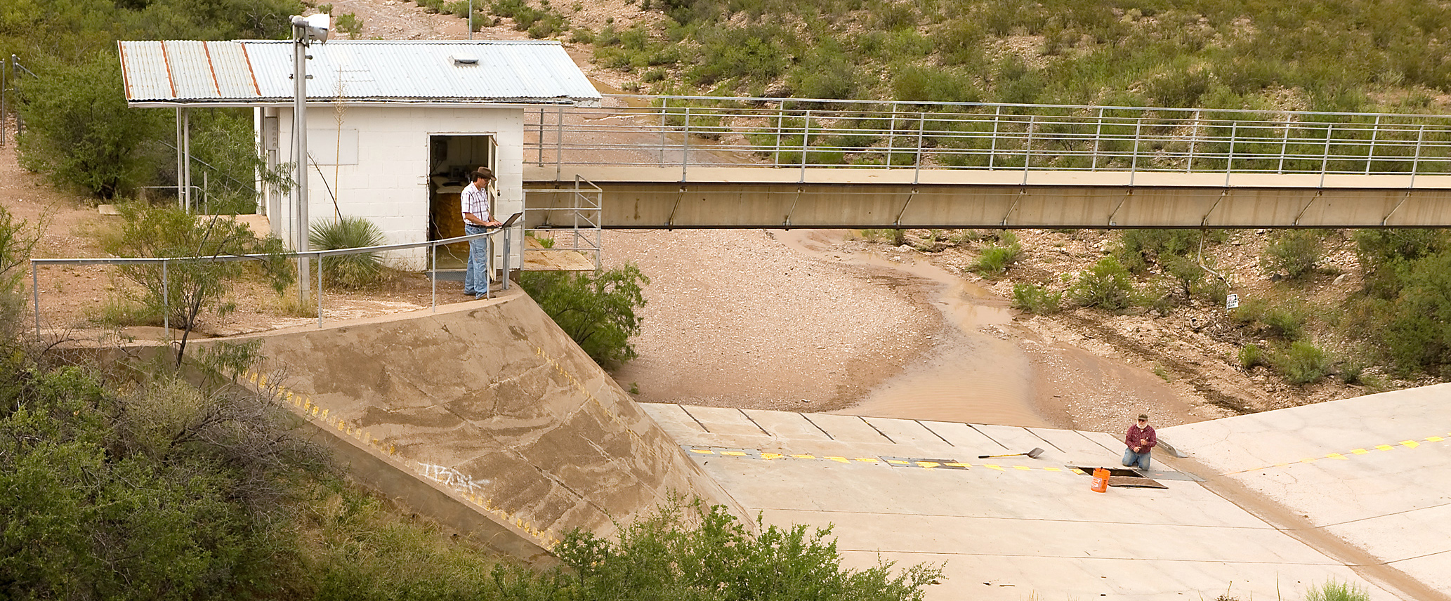 ARS technicians prepare a flume for monitoring runoff from the Walnut Gulch Experimental Watershed