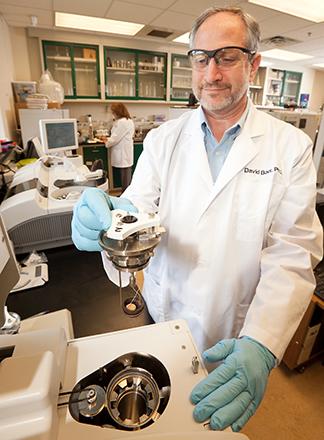 D2946 3 ARS physiologist David Baer holding a diet study sample in the laboratory