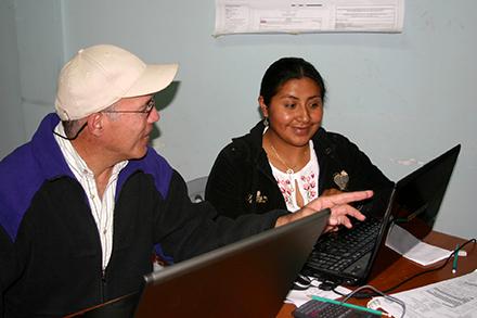 D5065-1 Jorge Delgado and Rosa Juana Arévalo sitting in front of laptops.