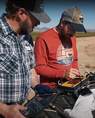 Two scientists looking at a soil map.