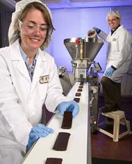 Research leader Tara McHugh and food technologist John Roberts prepare apple bars . 