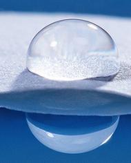A drop of water on paper with water resistant starch-based coating.